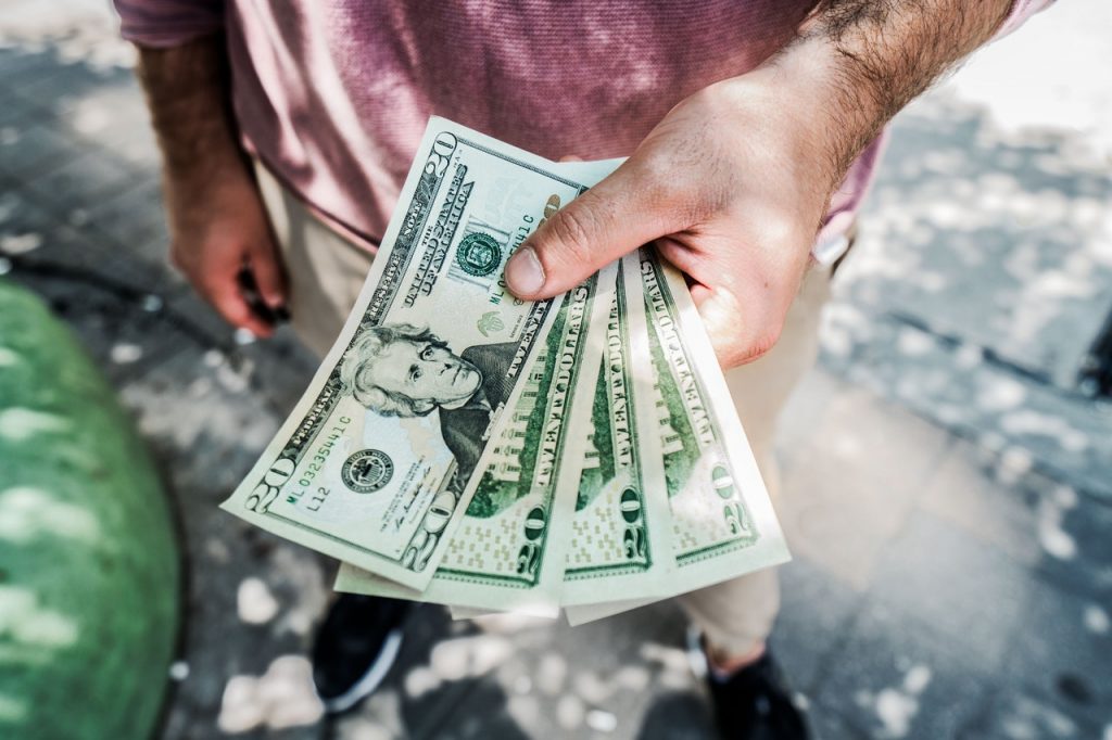 a man holding a stack of money