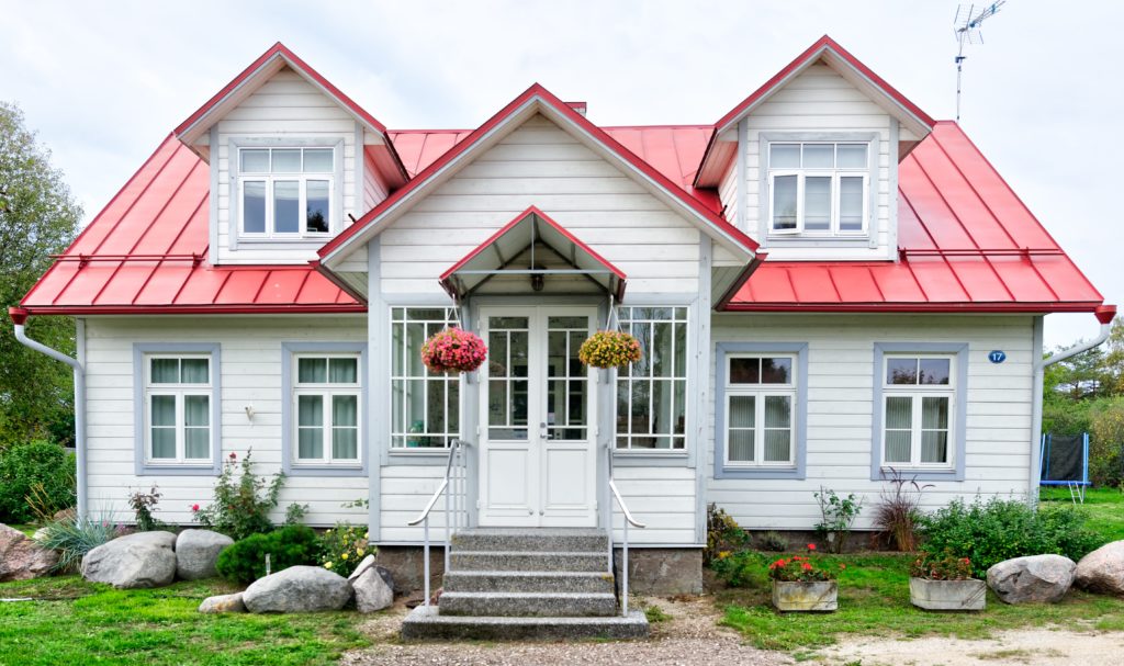 a pink house with a red roof