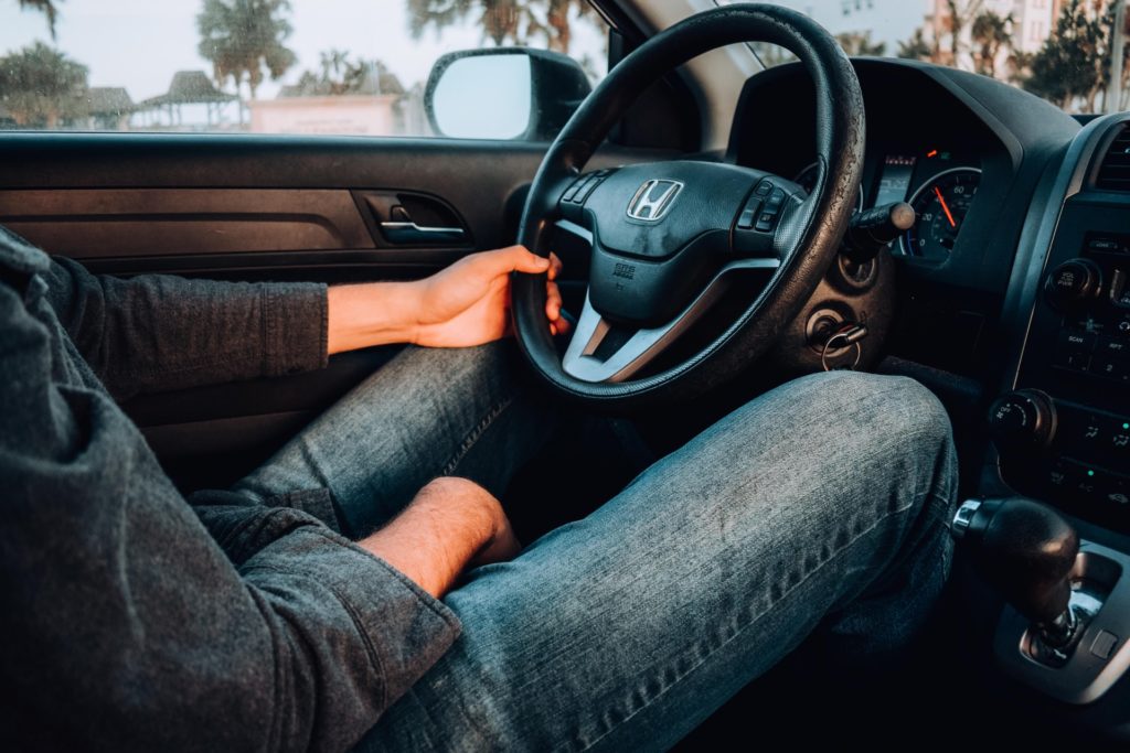 a man wearing a helmet driving a car