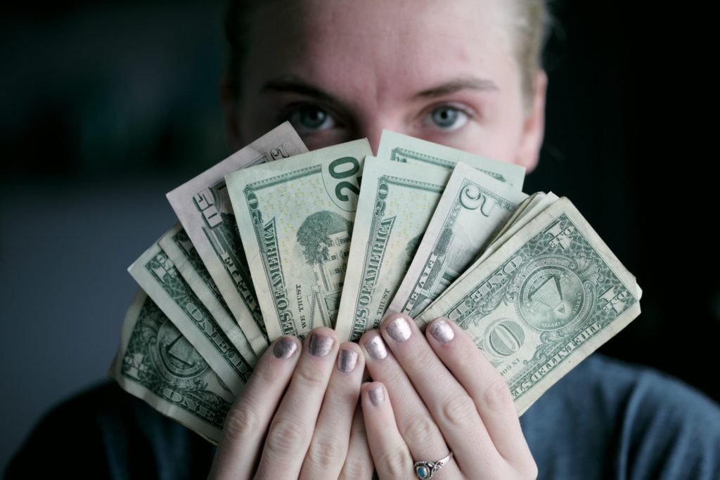 a person holding a stack of money