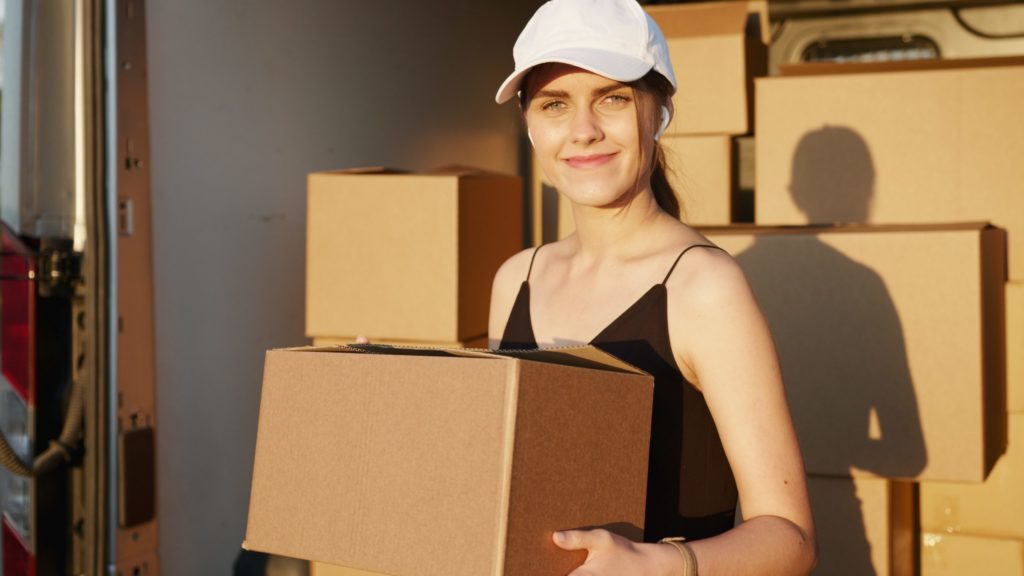 a woman wearing a hard hat and holding a laptop