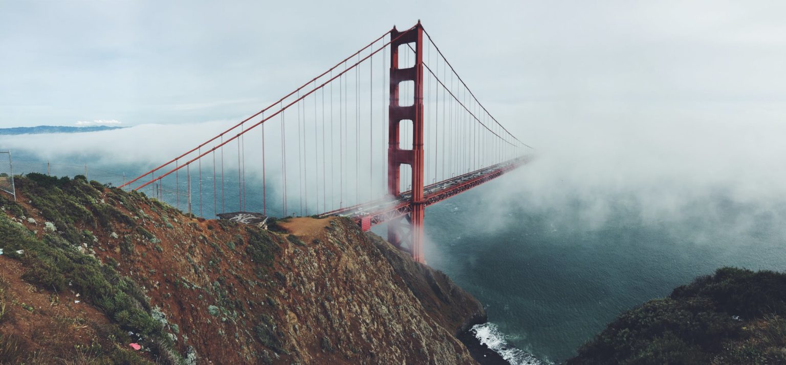 Golden Gate Bridge over a foggy mountain