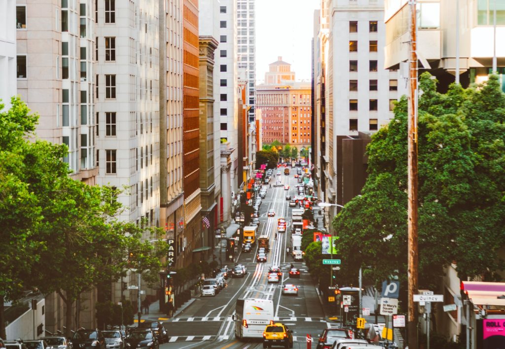 a street with cars and trees on it