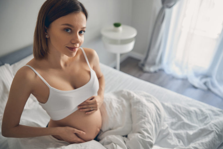 https://elements.envato.com/happy-pregnant-woman-wearing-in-white-bra-sitting--2FKM9VN